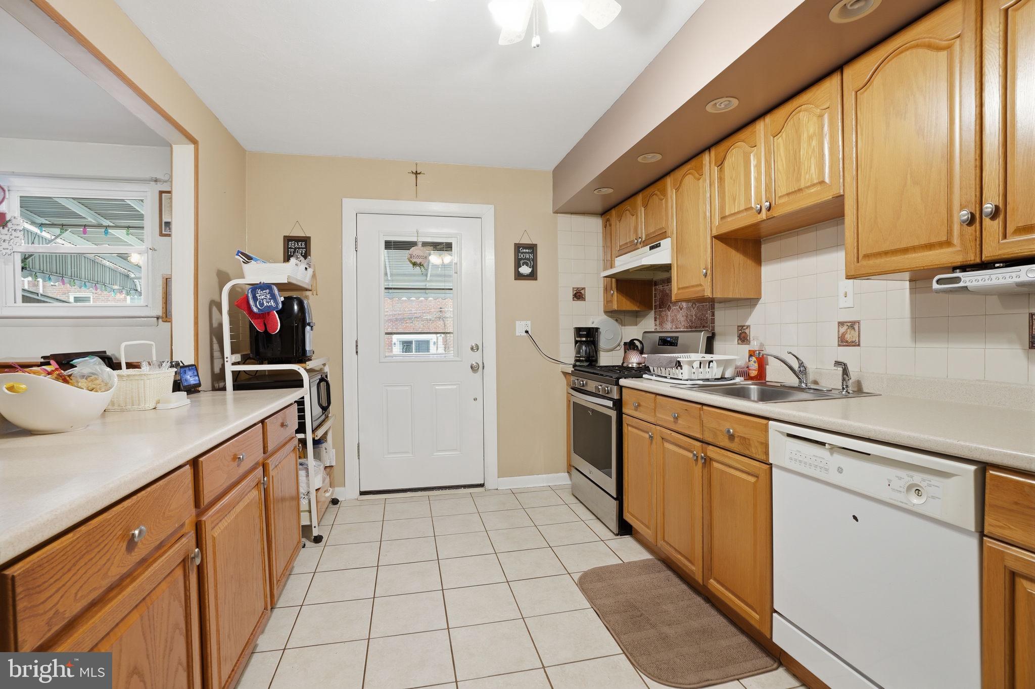 2824 Willits Road Philadelphia, PA 19136 - Photo 7 of 22 a kitchen with stainless steel appliances granite countertop a sink and cabinets