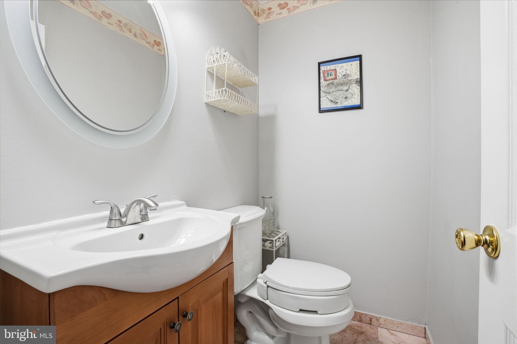 2824 Willits Road Philadelphia, PA 19136 - Photo 9 of 22 a bathroom with a sink a mirror and a toilet