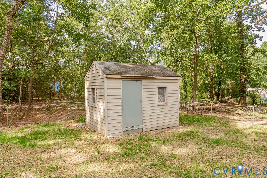 9514 Riddle Road Chesterfield, VA 23832 - Photo 48 of 50 View of shed with a fenced backyard and view of wo