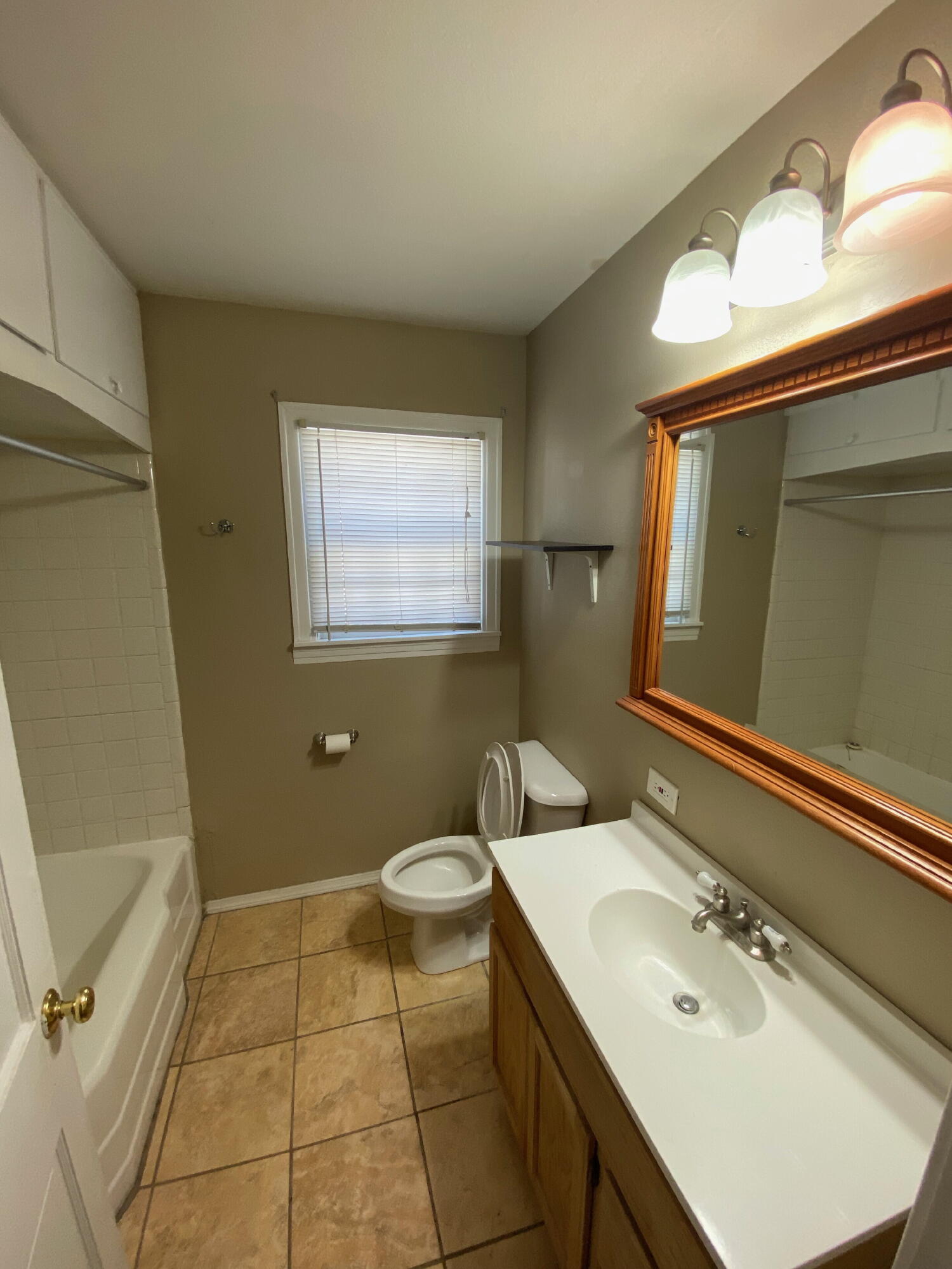 2520 27th Street, Unit FRONT Lubbock, TX 79410 - Photo 16 of 17 a bathroom with a sink toilet and mirror