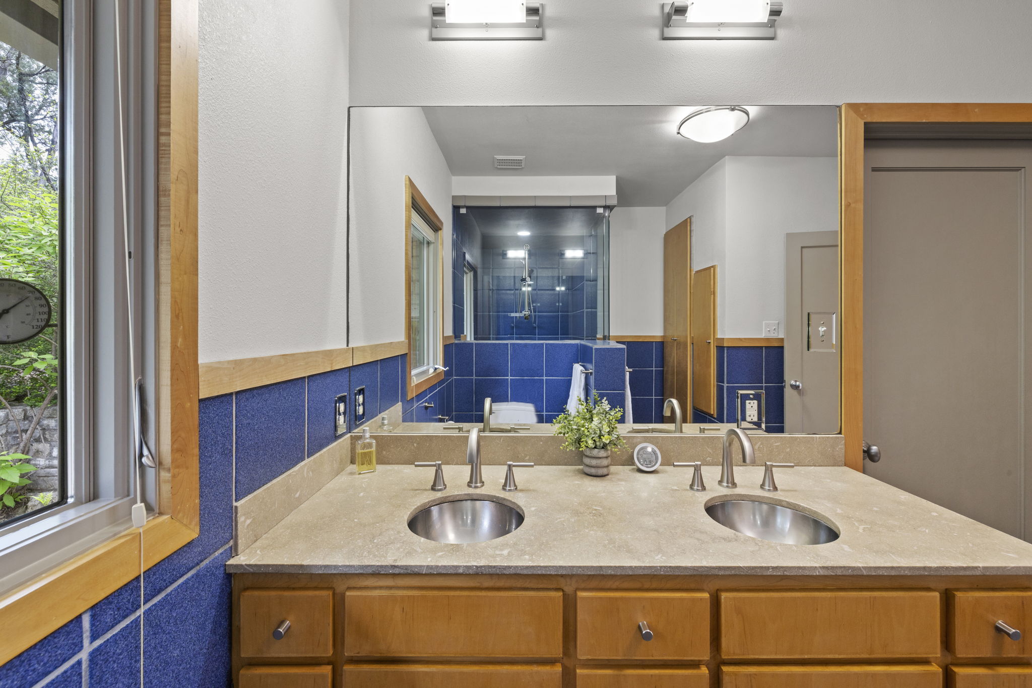 701 Yaupon Valley Road West Lake Hills, TX 78746 - Photo 20 of 40 Additional built-in storage is visible in the mirror behind the wooden doors.