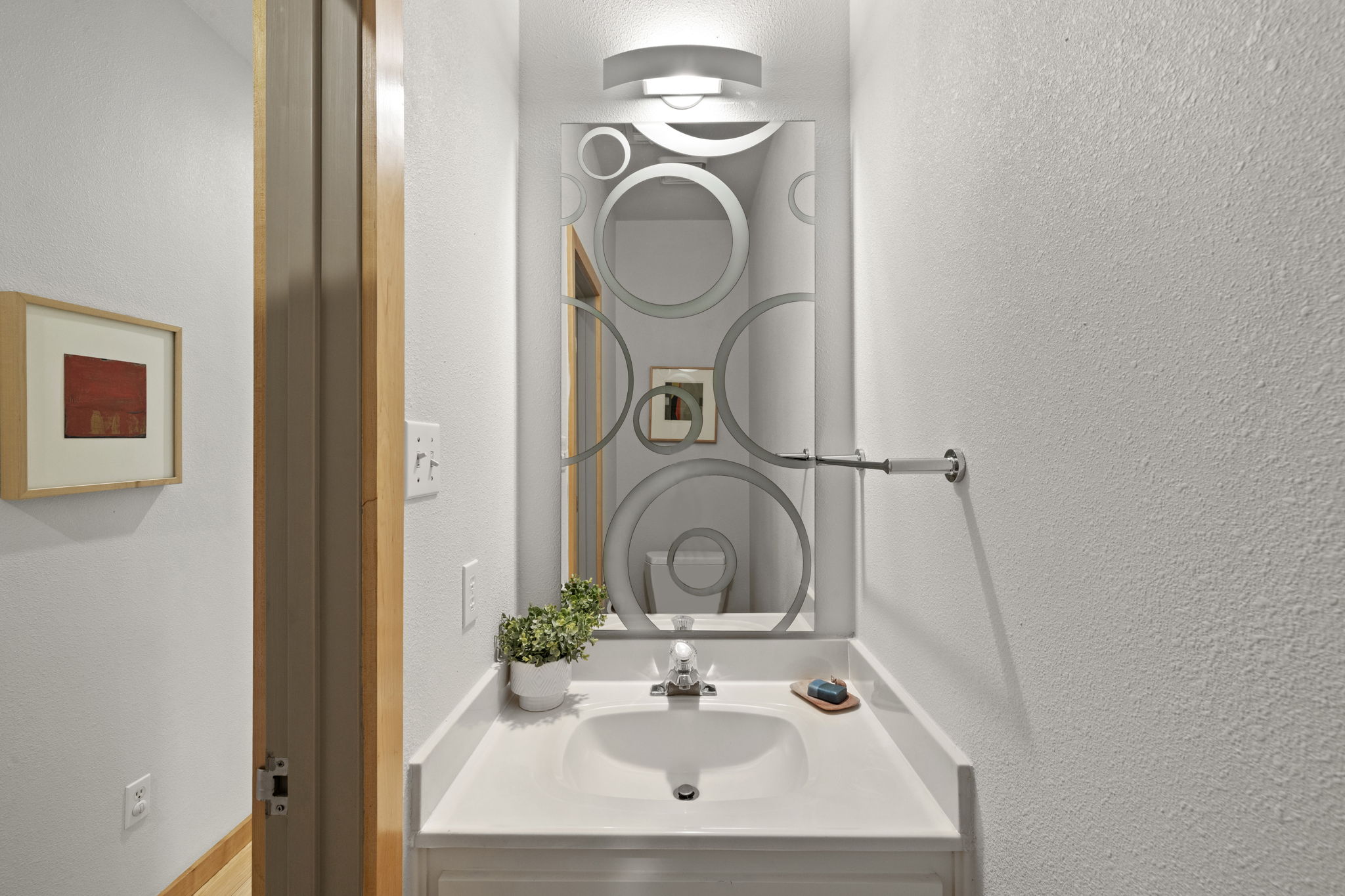 701 Yaupon Valley Road West Lake Hills, TX 78746 - Photo 22 of 40 This half bathroom is located in the hallway at the top of the stairs off the living room before you reach the primary suite. It's easy to miss!