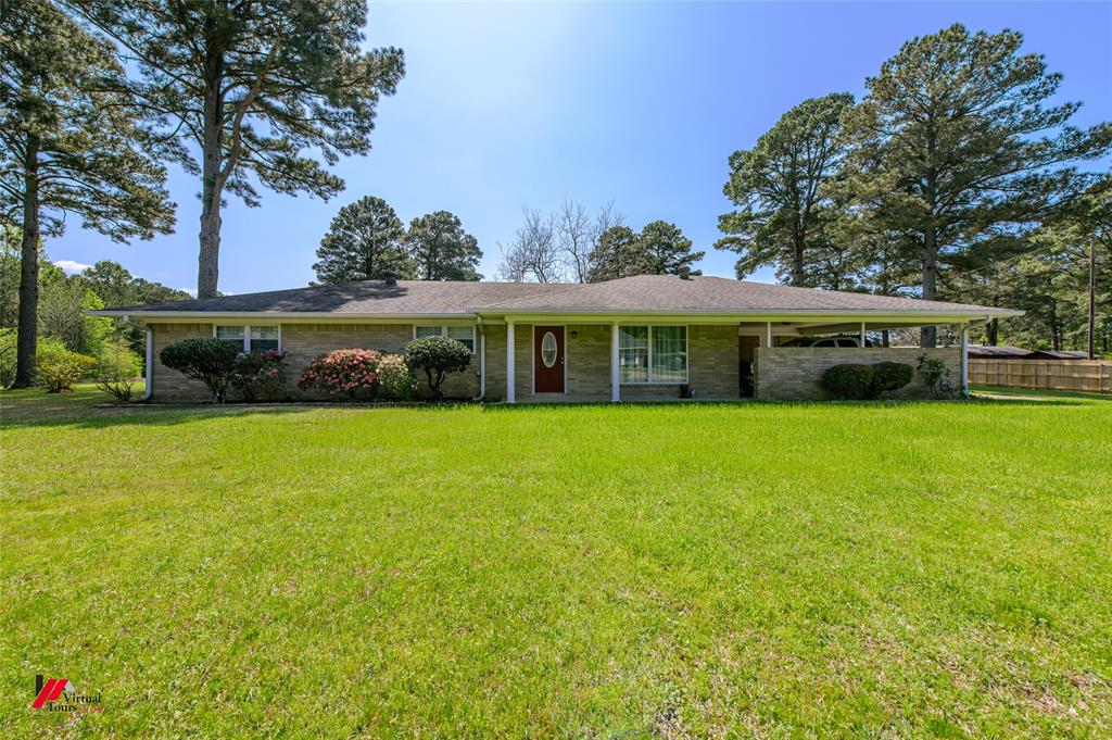 1201 Coyle Street Springhill, LA 71075 - Photo 1 of 1 Single story home with a carport and a front lawn