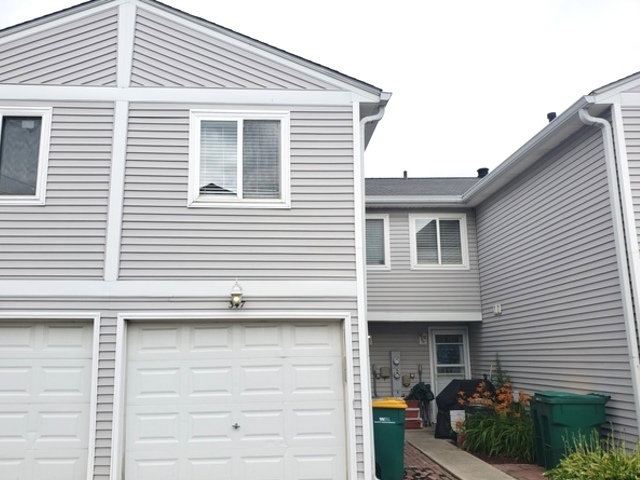 347 Meadow Green Lane Round Lake Beach, IL 60073 - Photo 1 of 22 a front view of a house with garage