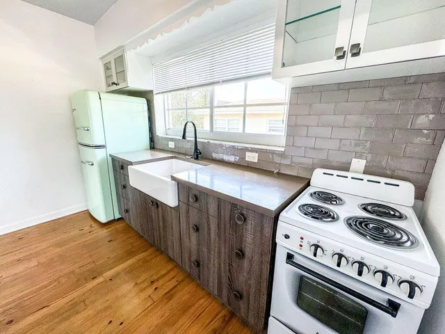 a kitchen with a stove a sink and a refrigerator