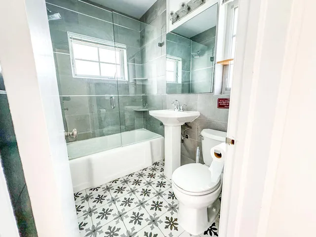 a bathroom with a sink toilet and shower