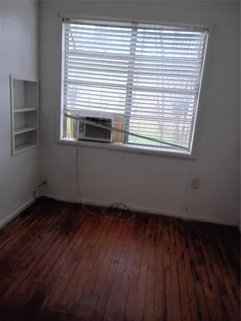 a view of an empty room and wooden floor