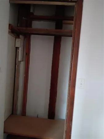 a view of walk in closet with empty racks