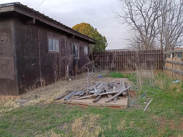 a backyard of a house with table and chairs