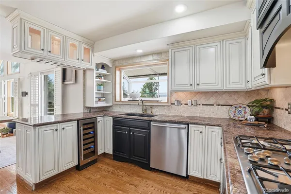 a kitchen with stainless steel appliances granite countertop a stove and a sink