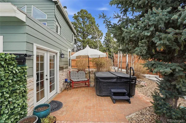 a patio with a table and chairs under an umbrella