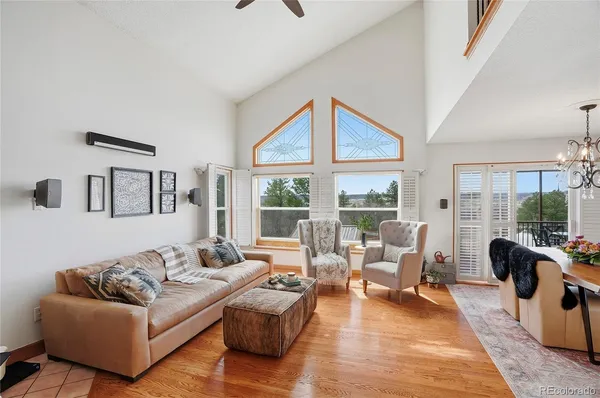 a living room with furniture large window and a table