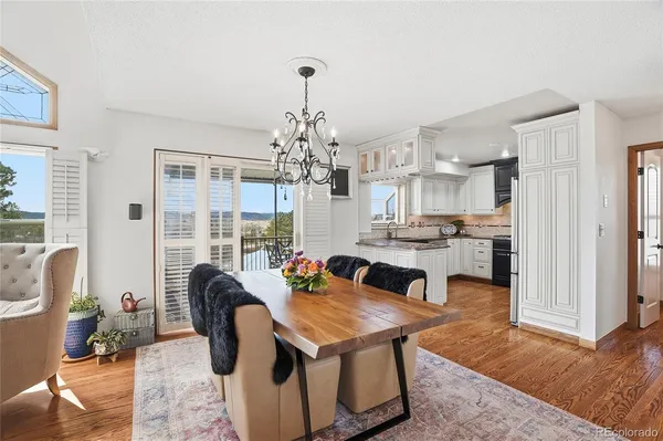 a living room with kitchen island furniture and a chandelier
