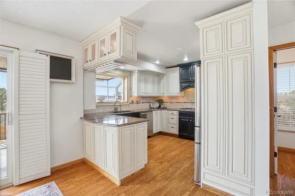 a kitchen with stainless steel appliances granite countertop a stove and a refrigerator
