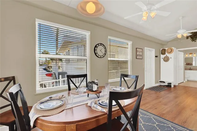 a view of a dining room with furniture and wooden floor