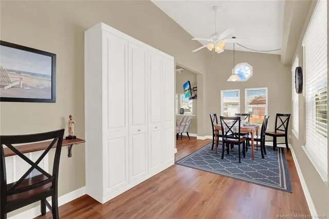 a bathroom with a toilet sink vanity granite and shower