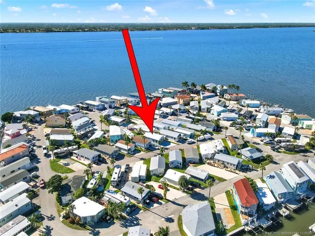 a living room with furniture kitchen and a window