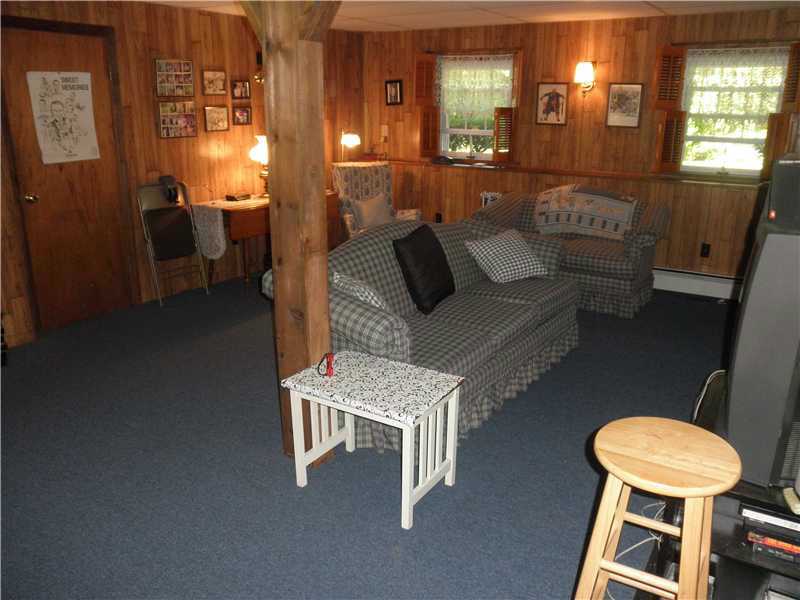 24 Swan Road Smithfield, RI 02917 - Photo 20 of 24 Den/Family/Great Room. Spacious Lower Level Family Room with Gas Fireplace, Dry Bar, + 1/2 Bath w/sliders to Patio and enclosed Porch!