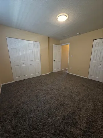 an empty room with closet and wooden floor