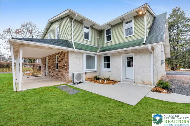 a front view of a house with a yard and porch