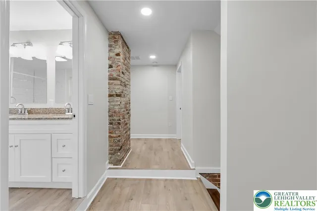 a view of bathroom with a shower and a sink