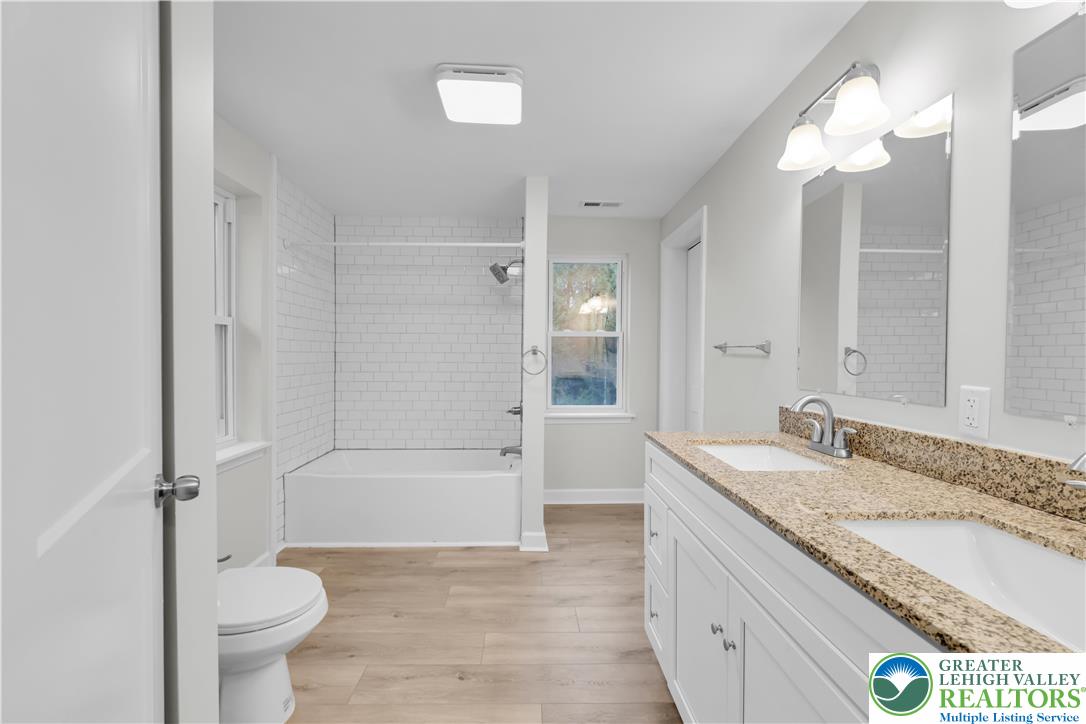 4453 Old Bethlehem Pike Center Valley, PA 18034 - Photo 19 of 28 a bathroom with a granite countertop sink toilet mirror and bathtub