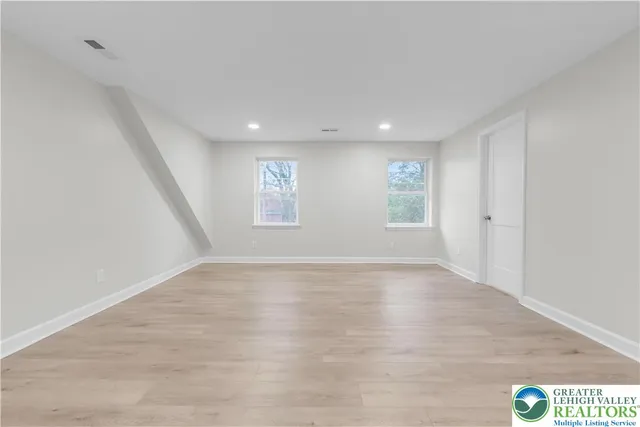 a view of an empty room and a window