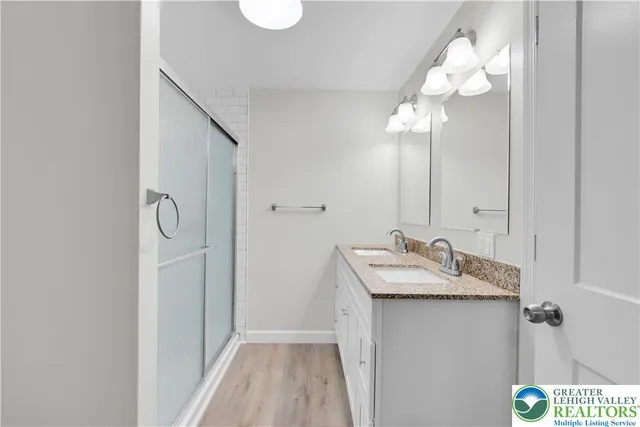a bathroom with a sink vanity and a mirror