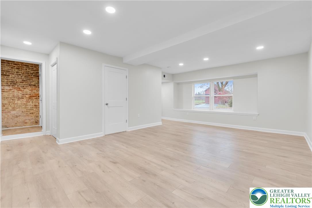 4453 Old Bethlehem Pike Center Valley, PA 18034 - Photo 5 of 28 an empty room with wooden floor and windows