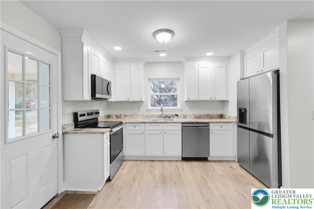 4453 Old Bethlehem Pike Center Valley, PA 18034 - Photo 10 of 28 a kitchen with a refrigerator a sink and a stove top oven