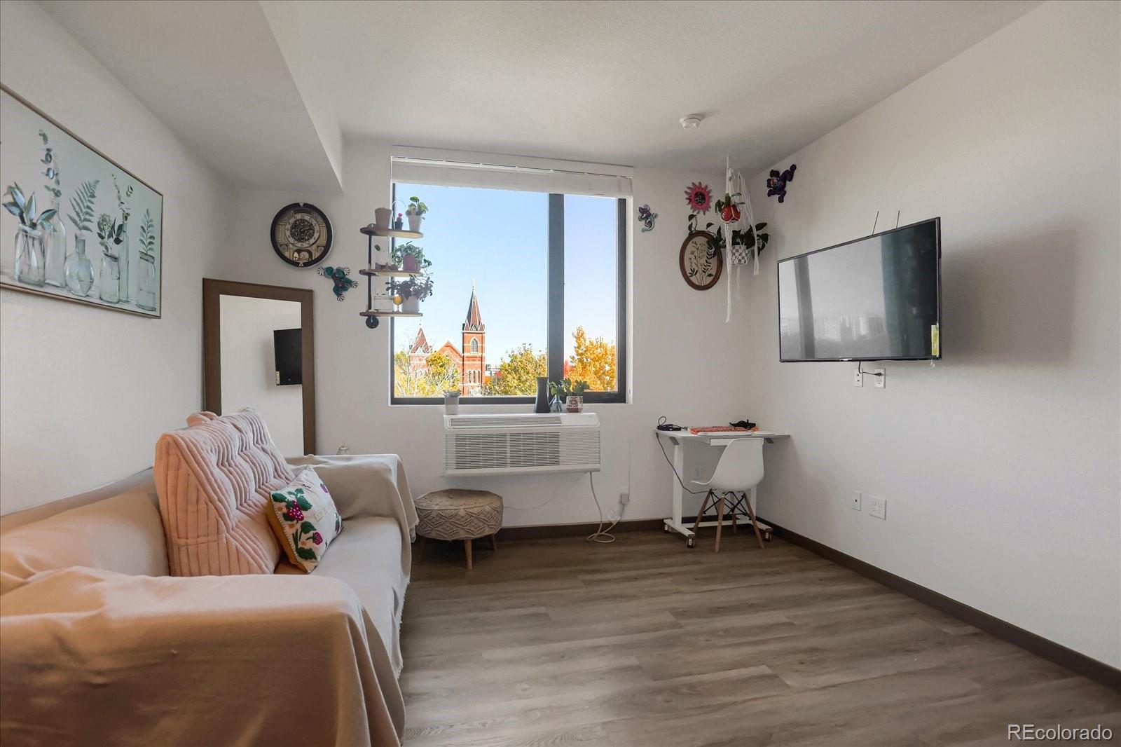 603 Inca Street, Unit 423 Denver, CO 80204 - Photo 5 of 20 a living room with furniture and a flat screen tv