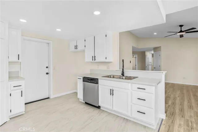 an empty room with a window and a ceiling fan