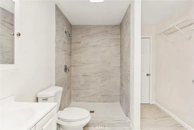 a white toilet sitting next to a bathroom sink