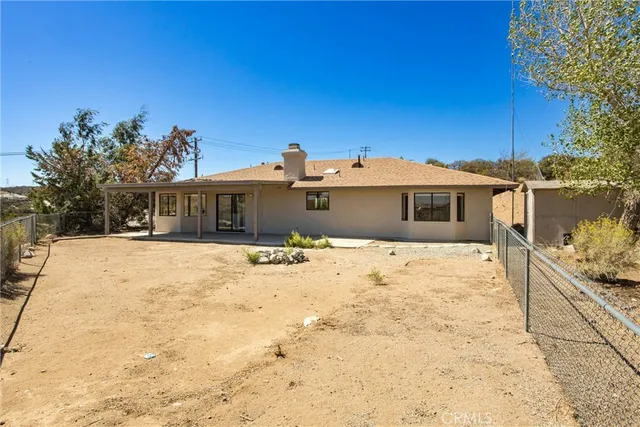 a view of a house with a yard covered with snow