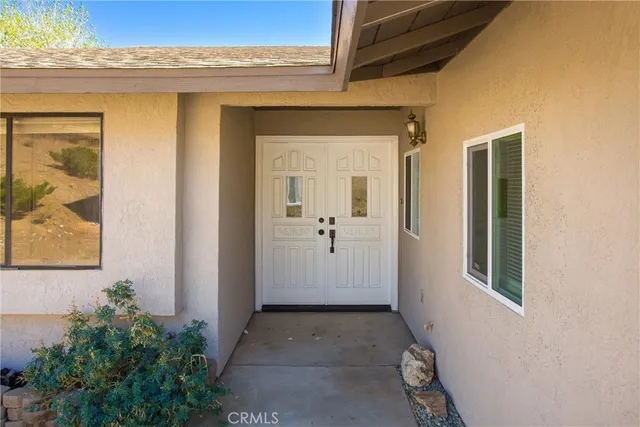 a view of a room with wooden floor and a ceiling fan