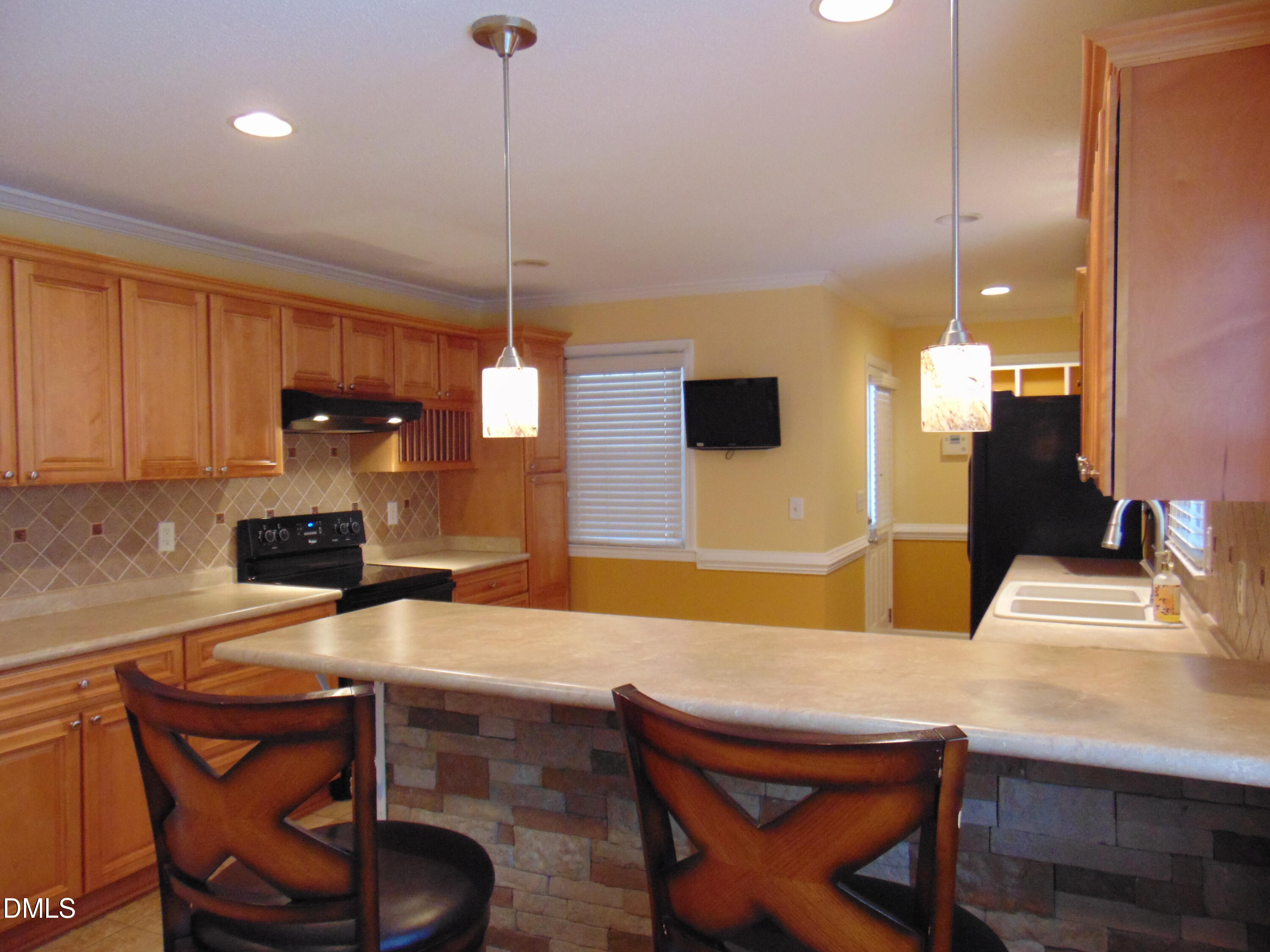 442 Gus Road Durham, NC 27703 - Photo 16 of 56 a kitchen with a table chairs and a refrigerator