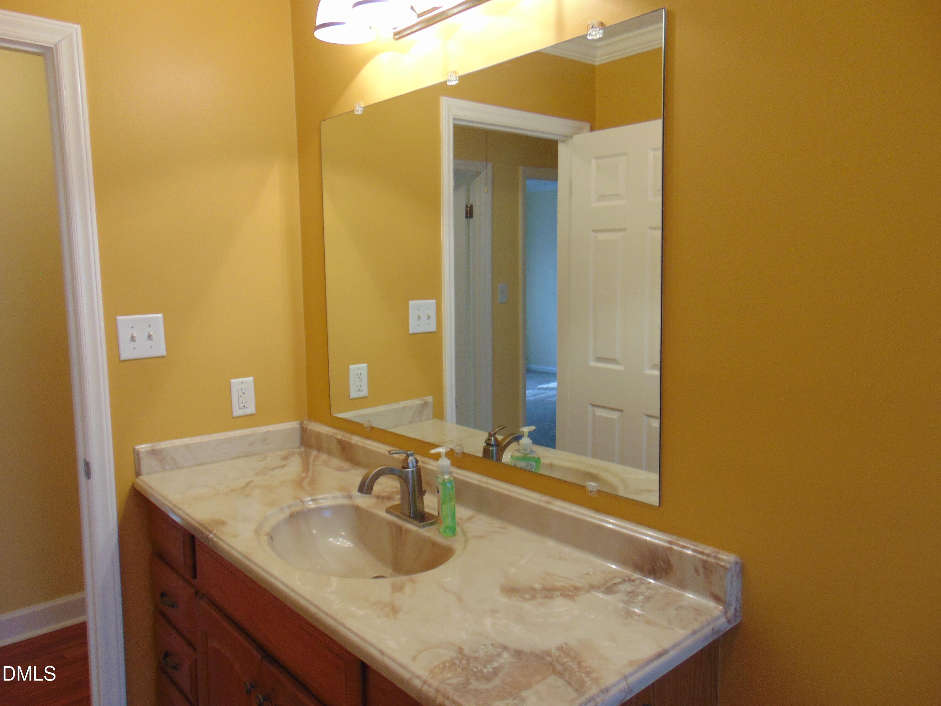 442 Gus Road Durham, NC 27703 - Photo 21 of 56 a bathroom with a granite countertop sink and a mirror