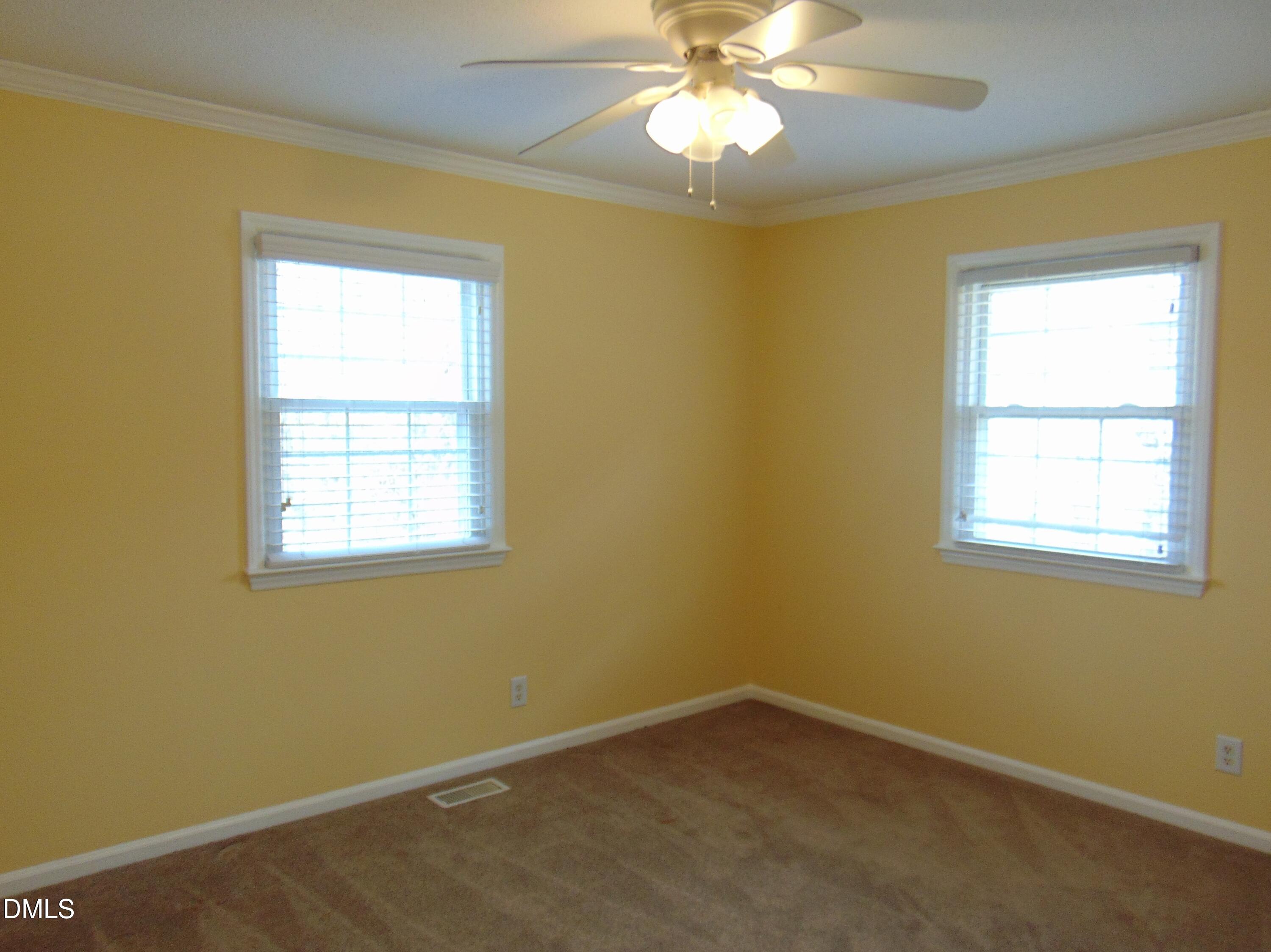 442 Gus Road Durham, NC 27703 - Photo 29 of 56 an empty room with a window and a chandelier fan