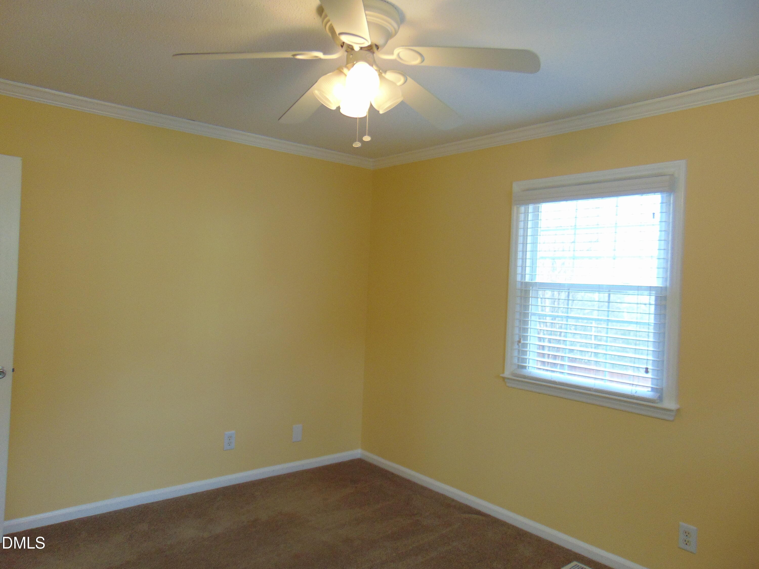 442 Gus Road Durham, NC 27703 - Photo 30 of 56 an empty room with a window and a ceiling fan