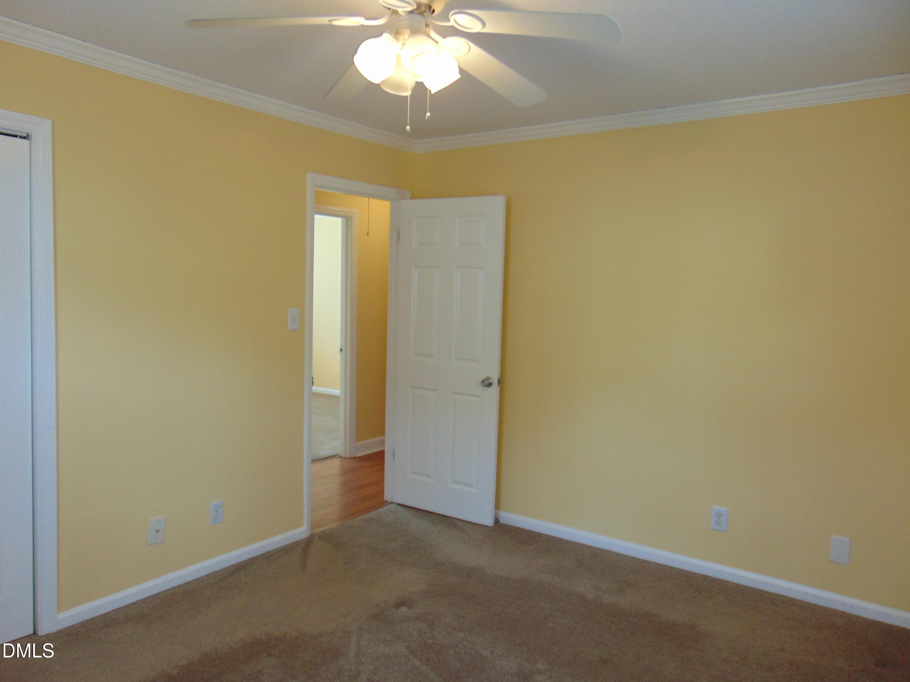 442 Gus Road Durham, NC 27703 - Photo 31 of 56 an empty room with a chandelier fan and a chandelier fan