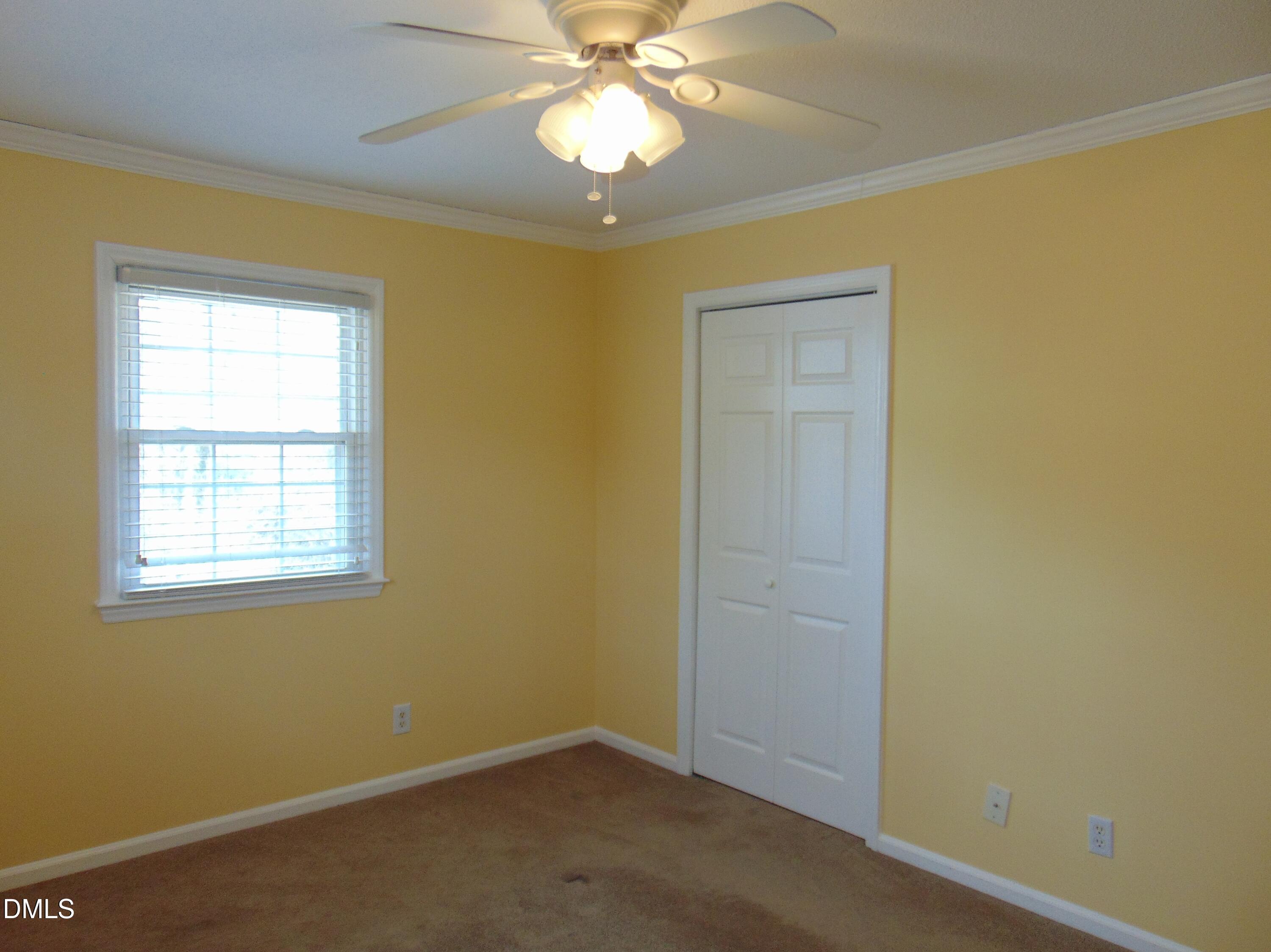 442 Gus Road Durham, NC 27703 - Photo 32 of 56 an empty room with a chandelier fan and a window