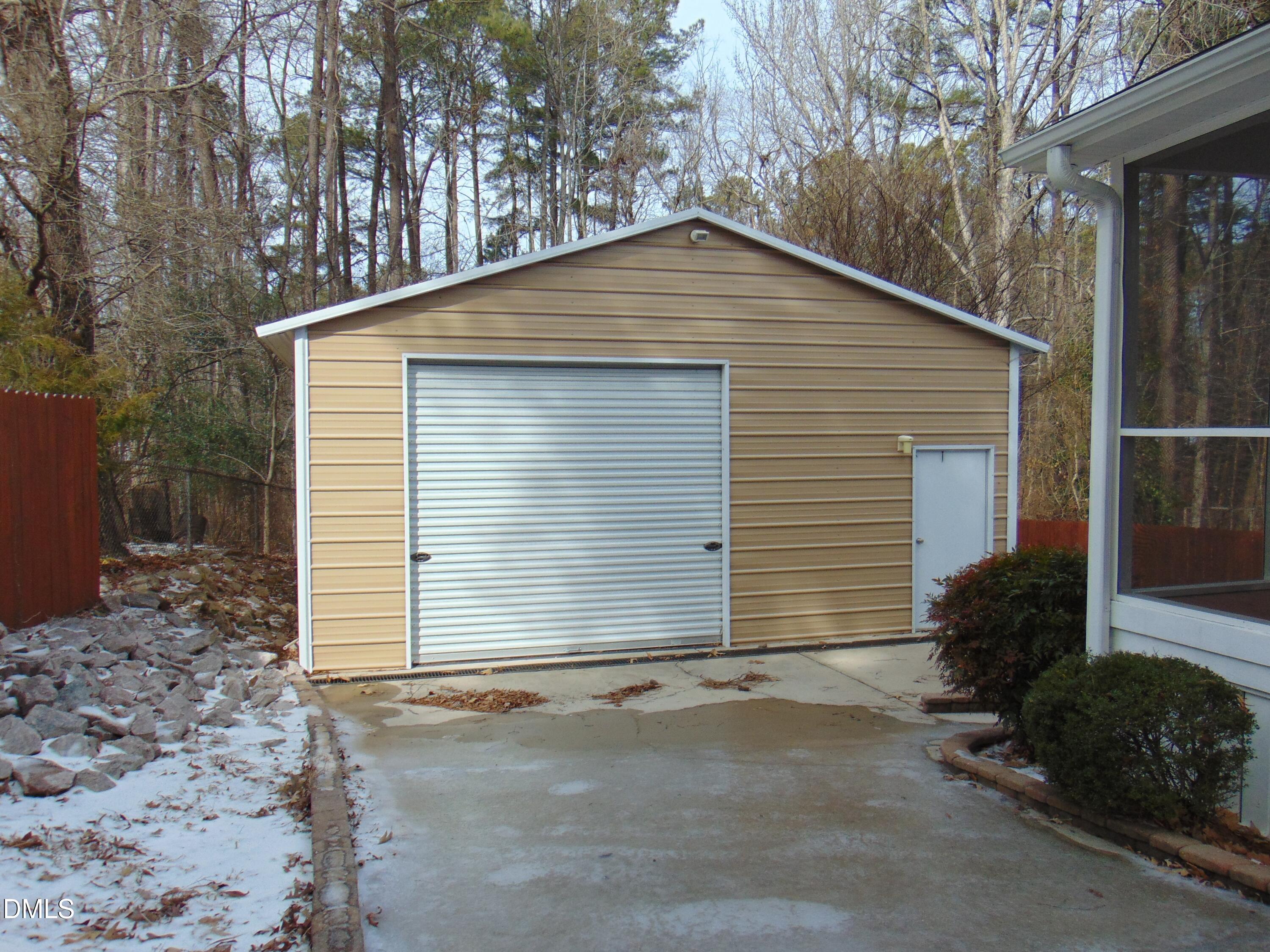 442 Gus Road Durham, NC 27703 - Photo 52 of 56 a house with a yard and garage