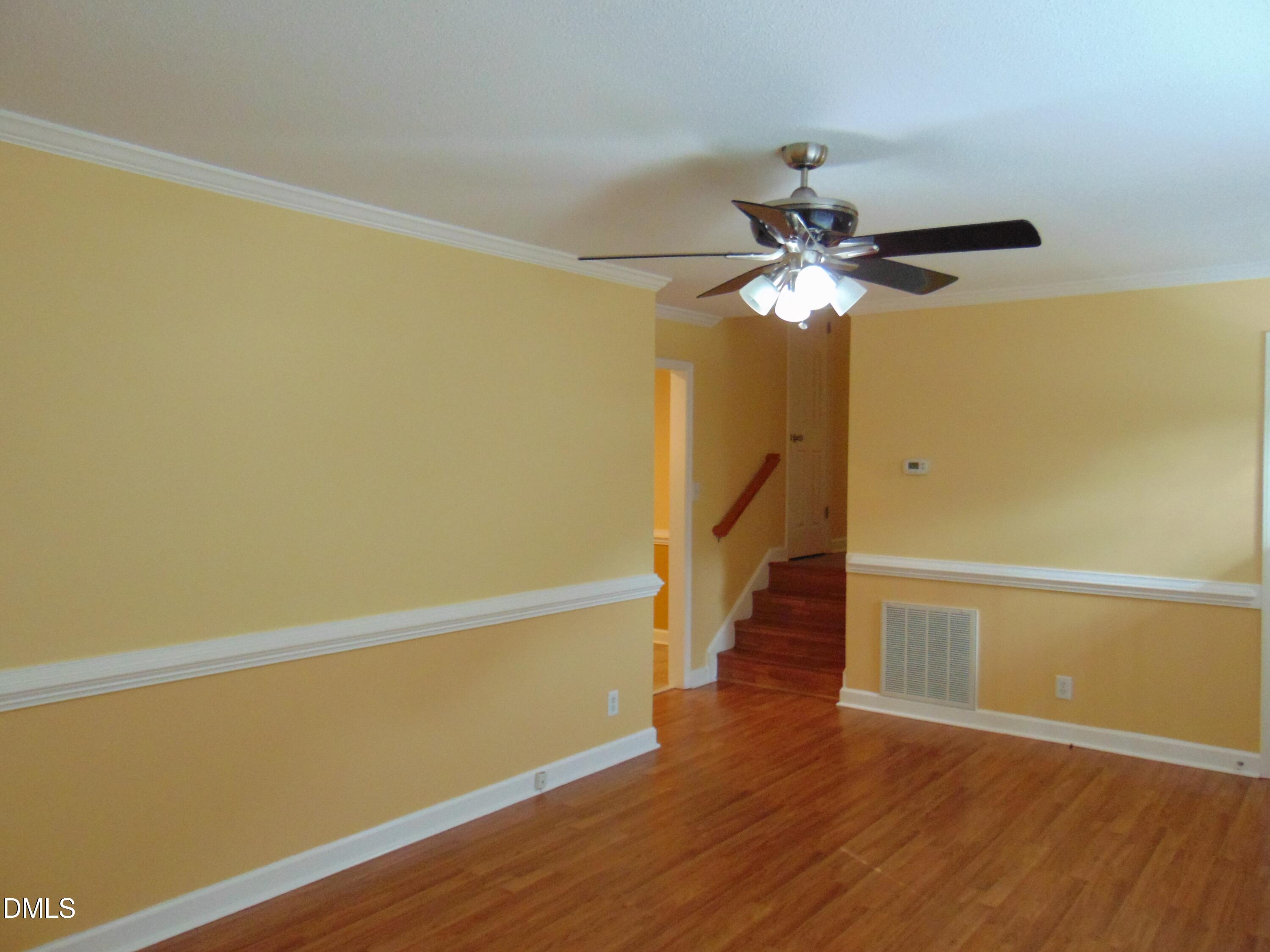 442 Gus Road Durham, NC 27703 - Photo 6 of 56 a view of a room with wooden floor and a ceiling fan