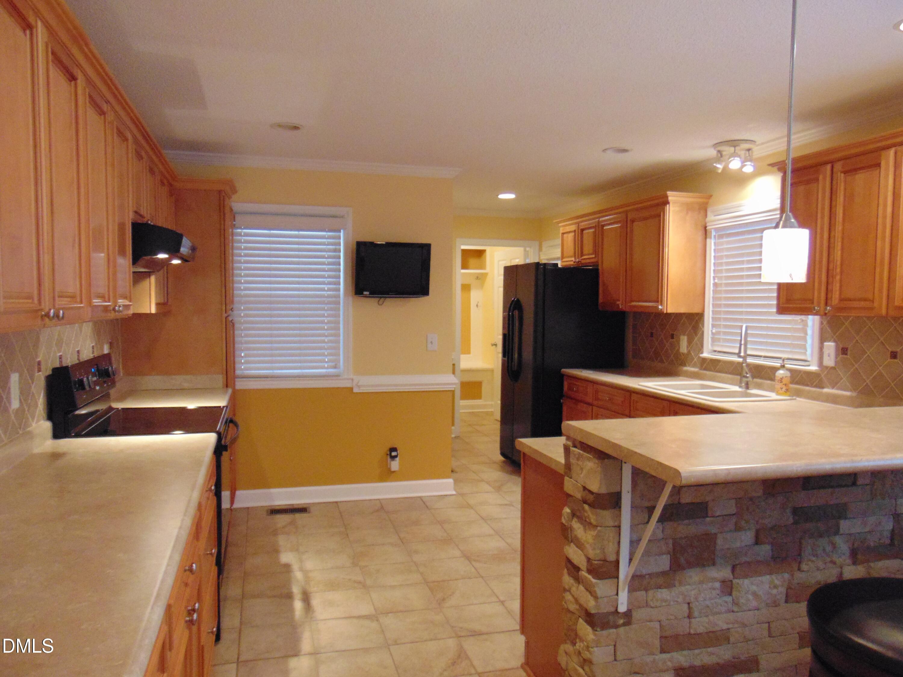 442 Gus Road Durham, NC 27703 - Photo 10 of 56 a kitchen with a sink a counter top space and stainless steel appliances