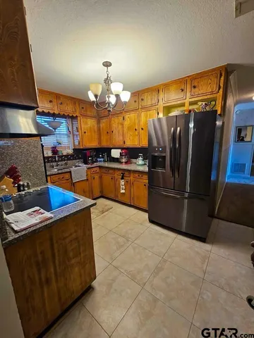 a kitchen with stainless steel appliances granite countertop a sink and cabinets
