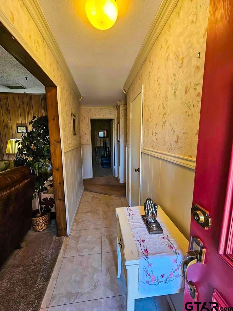 517 An County Road Palestine, TX 75801 - Photo 2 of 41 a hallway with a couch and wooden floor
