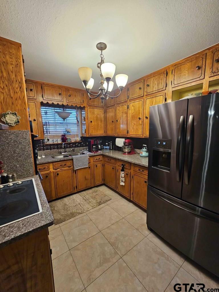517 An County Road Palestine, TX 75801 - Photo 23 of 41 a kitchen with stainless steel appliances a refrigerator a stove a sink dishwasher and microwave