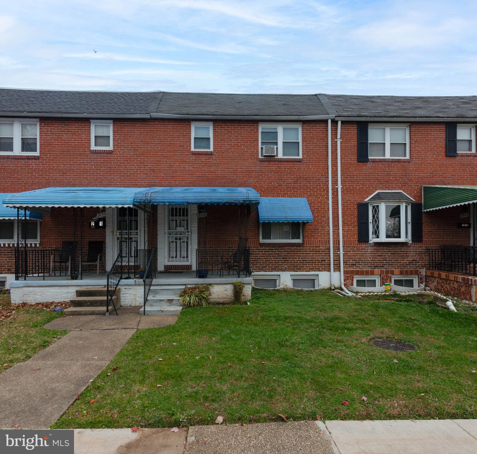 3040 Federal Street Baltimore, MD 21213 - Photo 1 of 38 a front view of a house with a yard