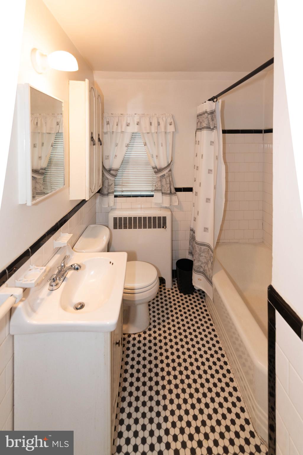 3040 Federal Street Baltimore, MD 21213 - Photo 12 of 38 a bathroom with a sink toilet and shower