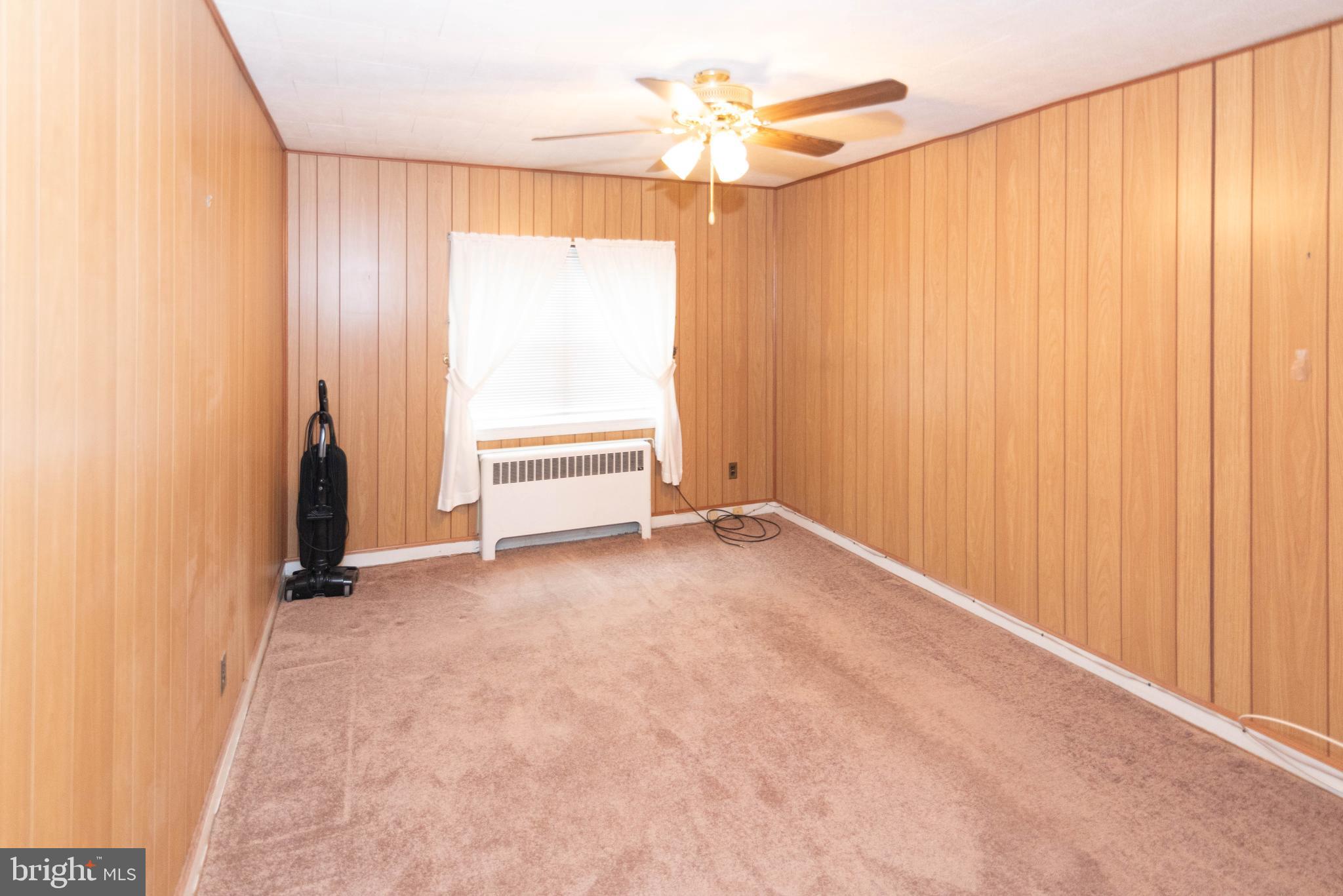 3040 Federal Street Baltimore, MD 21213 - Photo 16 of 38 an empty room with ceiling fan and window